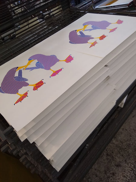 Two brightly coloured blue footed boobies dancing print on the drying rack