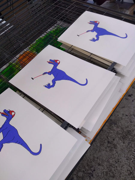 Print of a Blue velociraptor playing golf in a red baseball cap