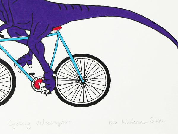 Print of a purple velociraptor cycling along happily on a teal bicycle