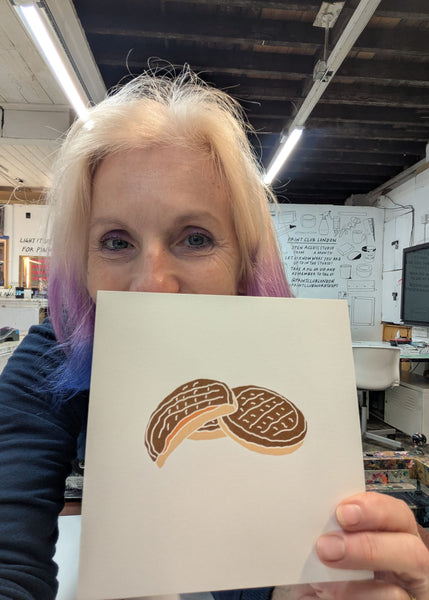 Liz holding a print of Jaffa Cakes