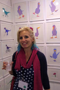 Liz in front of her screen prints at an art fair
