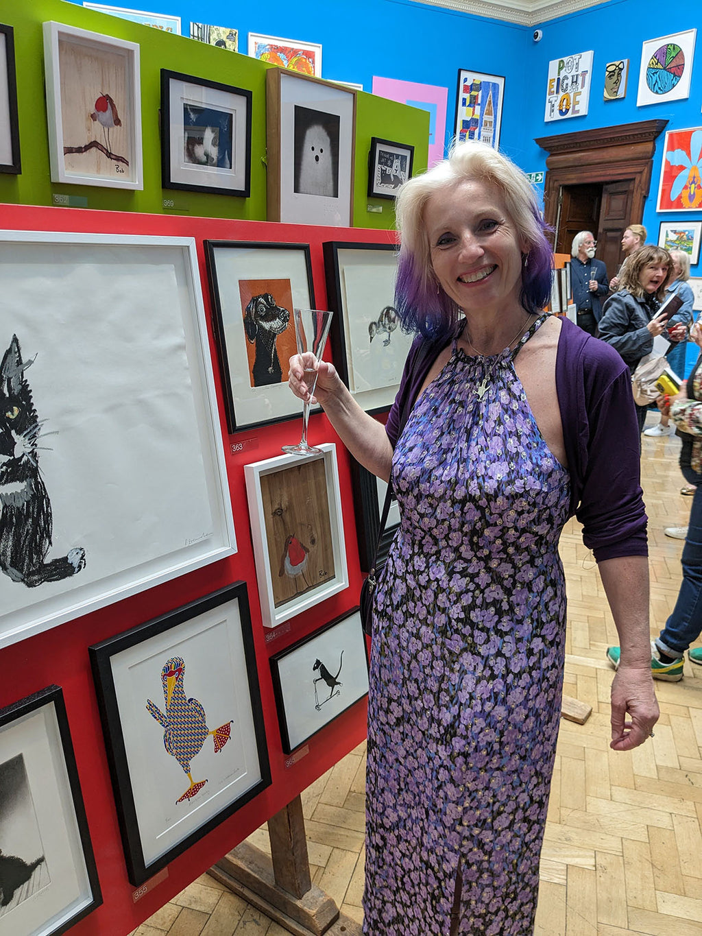 Liz at the Royal Academy next to the Rainbow booby bird print