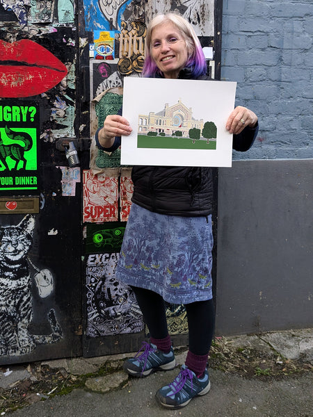 Liz holding a Print of Alexandra Palace in North London