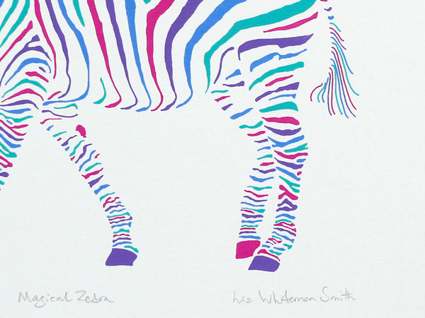 A colourful screen print of a zebra walking in profile, filled with vibrant, multicoloured zebra-stripe patterns in pink, blue, purple, and teal on a white background. Signed and numbered by artist Liz Wihiteman Smith.
