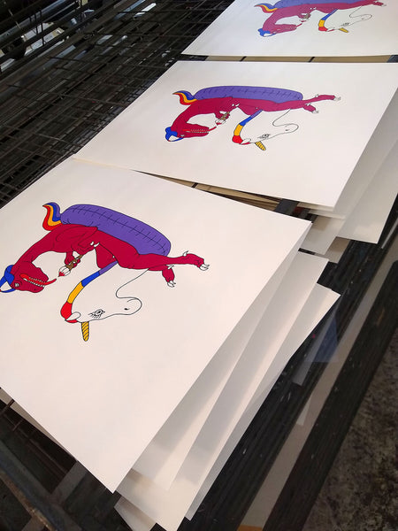 print of a pink velociraptor on a unicorn inflatable