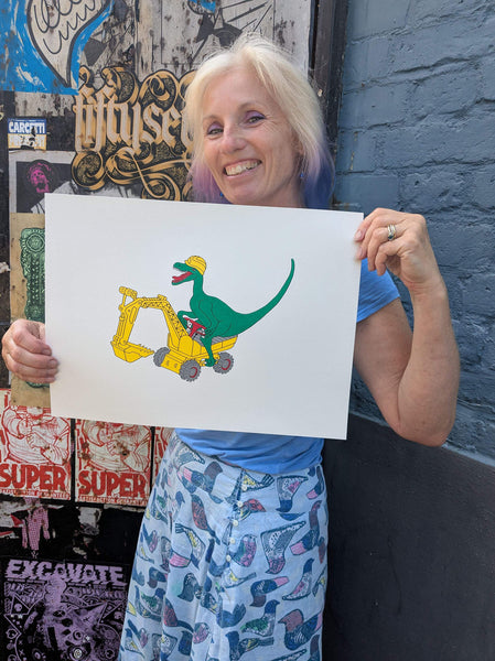 Print of a Green dinosaur on a yellow digger held by Lz